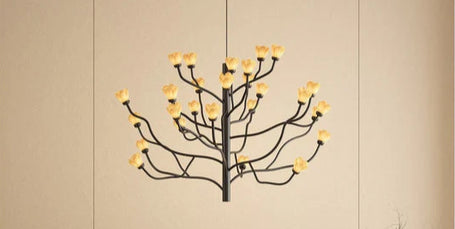 Modern bedroom with a bed and decorative chandelier against a beige wall.