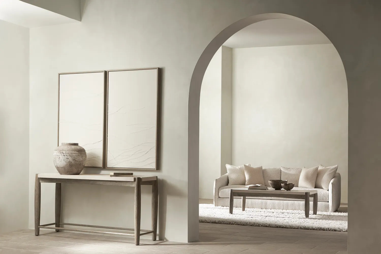 Modern living room with a sofa, coffee table, and decorative items.