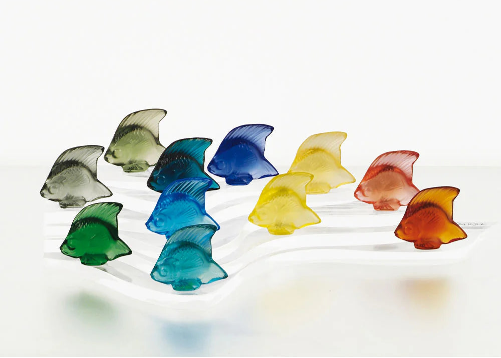 Colorful glass fish-shaped objects on a white background