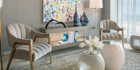 Modern living room with a chandelier, armchairs, and decorative items.