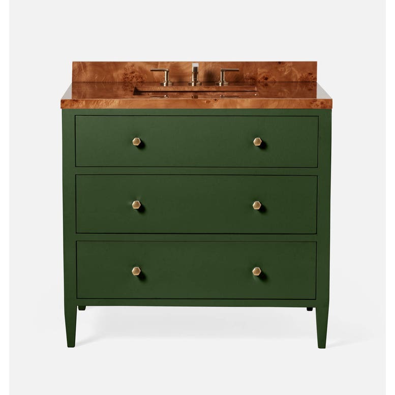 Green vanity base with three drawers and a polished, light wood countertop featuring a sink and gold faucet fixtures. 