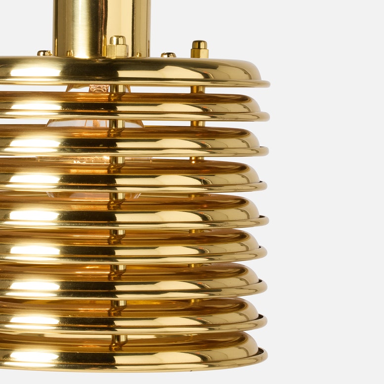 A modern gold jarvis pendant lamp with a sleek, ribbed design and warm light, adding elegance to contemporary interiors.