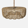A wovenkarimah pendant light with a circular design, suspended from a braided rope, casting a warm glow.